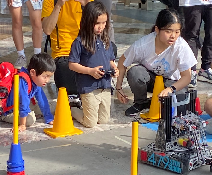 Young child driving a robot